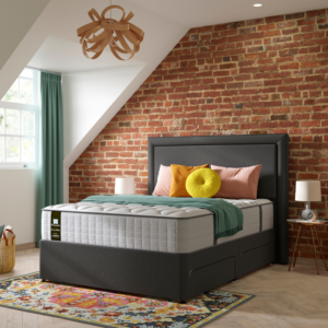 Studio image taken at an angle of the Sealy Emin mattress on a bed