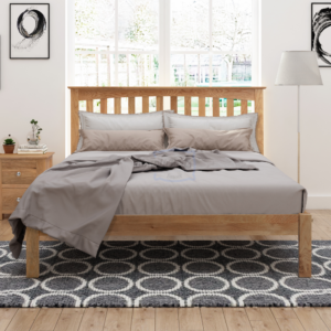 Gladstone solid oak bed frame with a mattress dressed in bedding and pillows