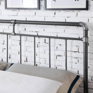 Studio image close up photo of the headboard on a black and silver industrial looking metal bed frame