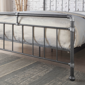Studio image close up photo of the footboard on a black and silver industrial looking metal bed frame