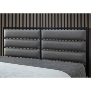 Close up of modern headboard with black surround and padded grey faux leather sections