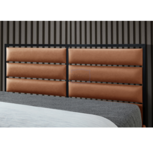 Close up of modern headboard with black surround and padded tan faux leather sections