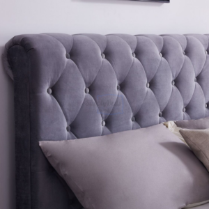 sleigh bed close up on roll top headboard