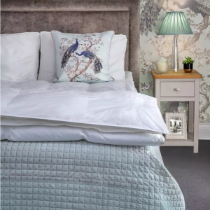 Lifestyle image of half a bed dressed with a duvet in a duvet cover