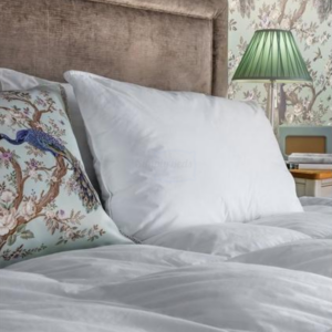 Lifestyle image of a Laura Ashley pillow on a bed