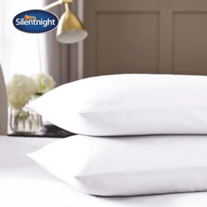 Studio Image of 2 pillows stacked on a bed with white pillow covers on
