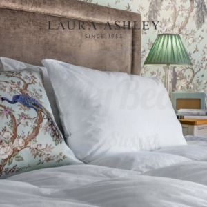 Lifestyle image of a Laura Ashley pillow on a bed