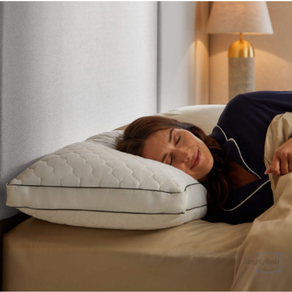 Image of a lady laying her head on a Sealy Side Sleeper pillow