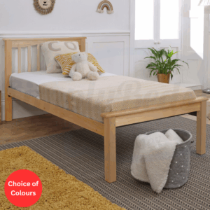 Lifestyle image of a beech wooden bed frame with low foot end and a semi dressed mattress